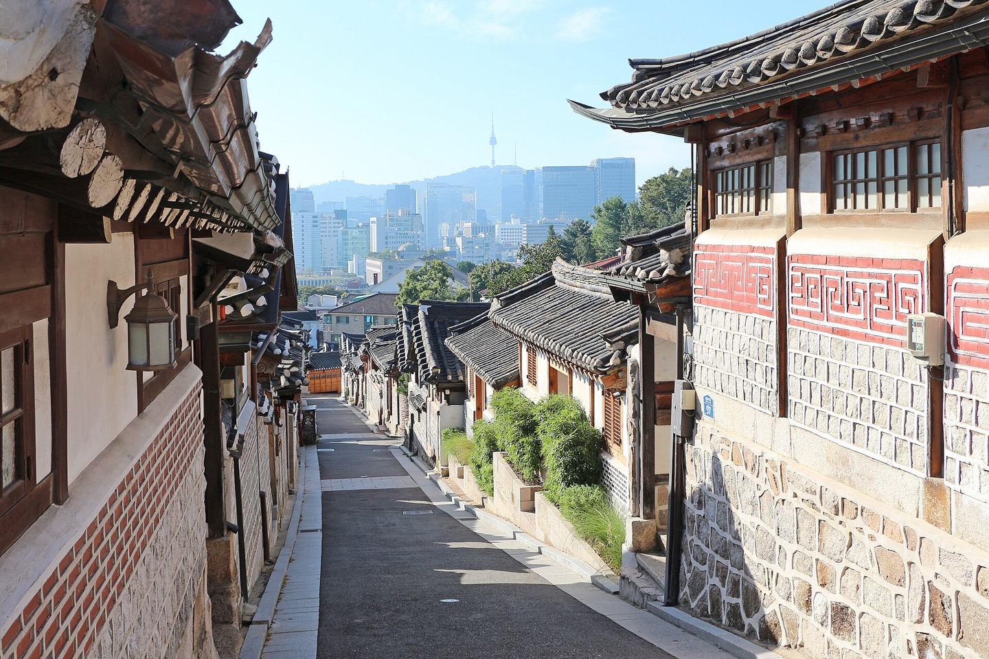 Traditional tiled roofs and a quiet street in Bukchon Hanok Village